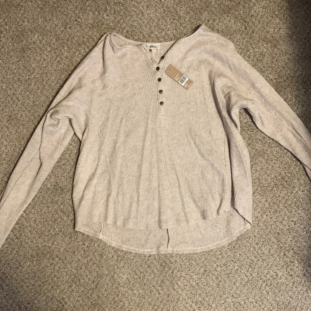 Brand new with tags Buckle long sleeve top. Size XS. Color: Stone.